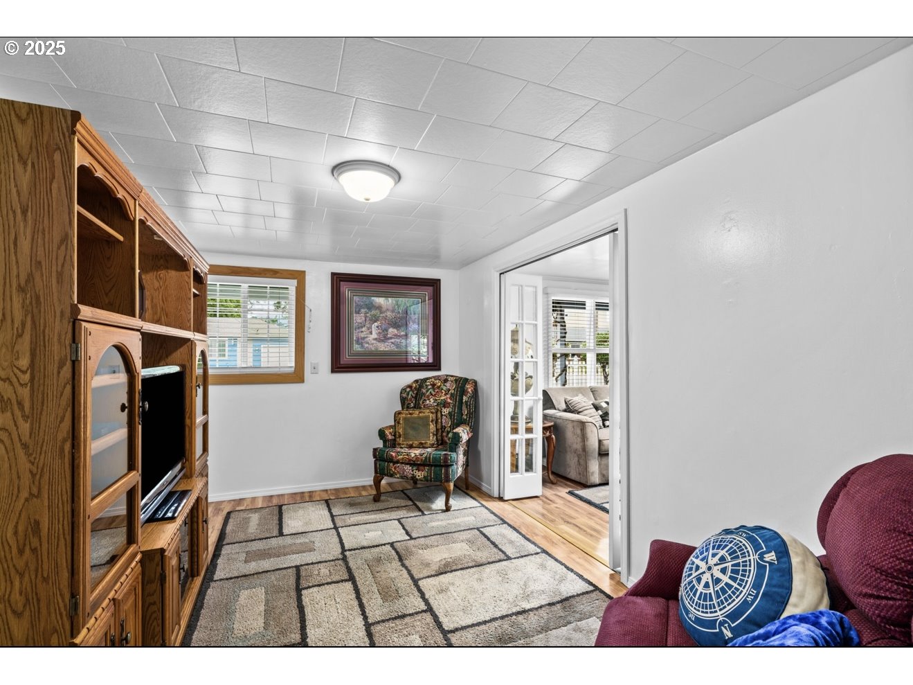 1995 Scott Road Springfield, OR 97477 - Photo 14 of 43 a living room with furniture a flat screen tv and a refrigerator