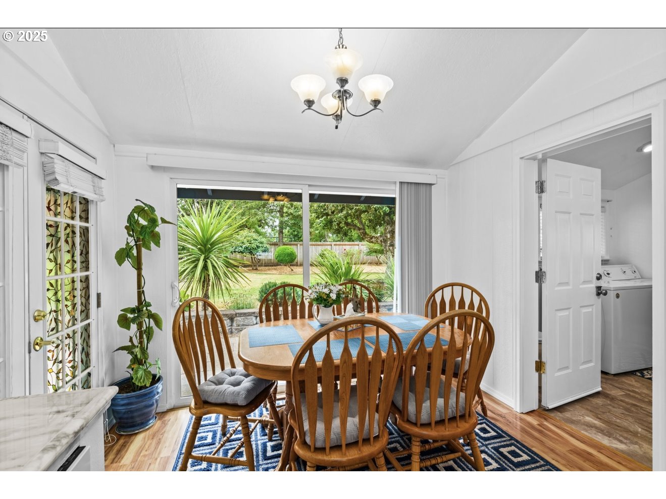1995 Scott Road Springfield, OR 97477 - Photo 19 of 43 a view of a dining room with furniture a chandelier and wooden floor