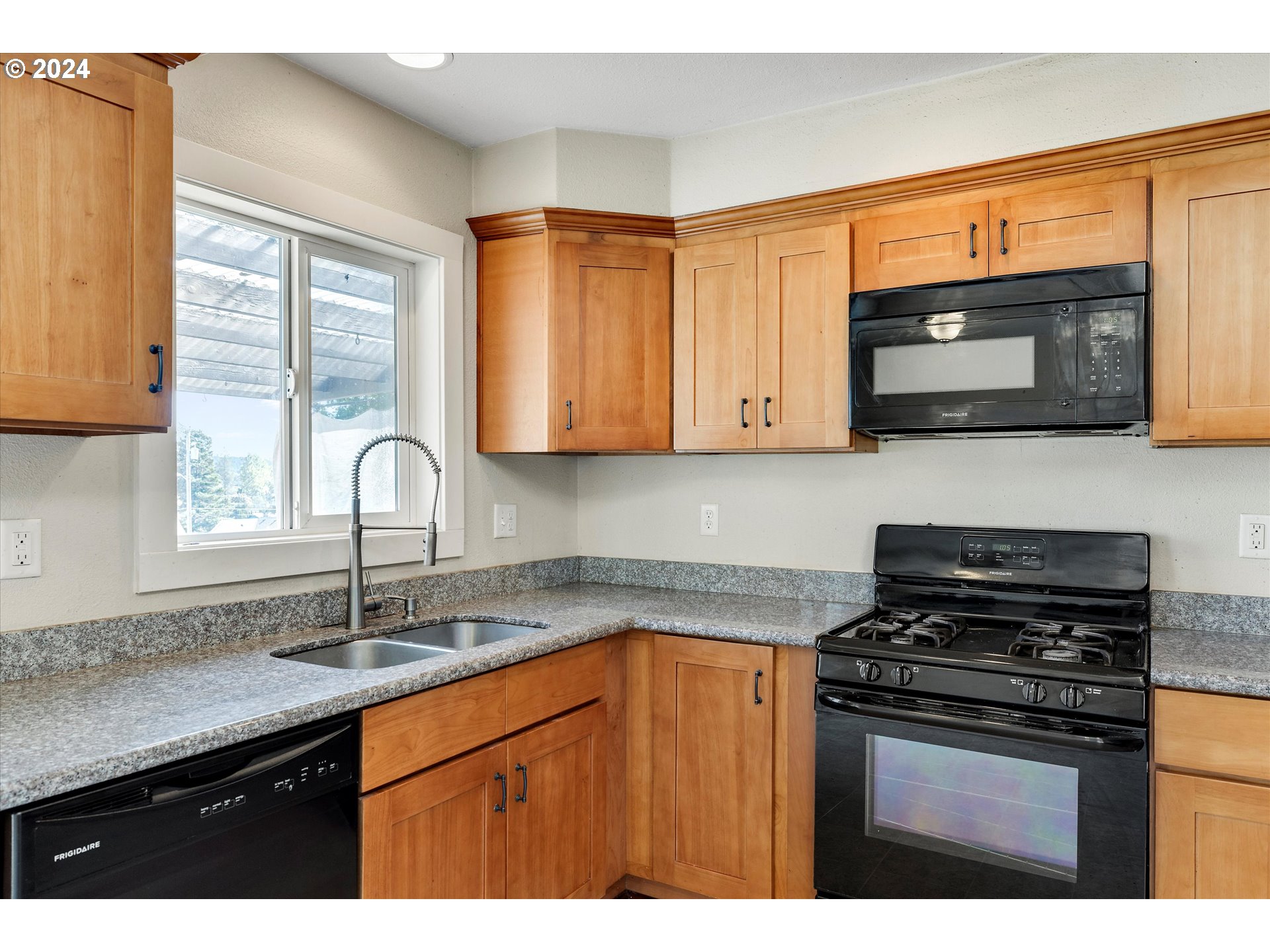 362 Southwest Oak Street Willamina, OR 97396 - Photo 11 of 34 a kitchen with stainless steel appliances granite countertop a sink stove and microwave