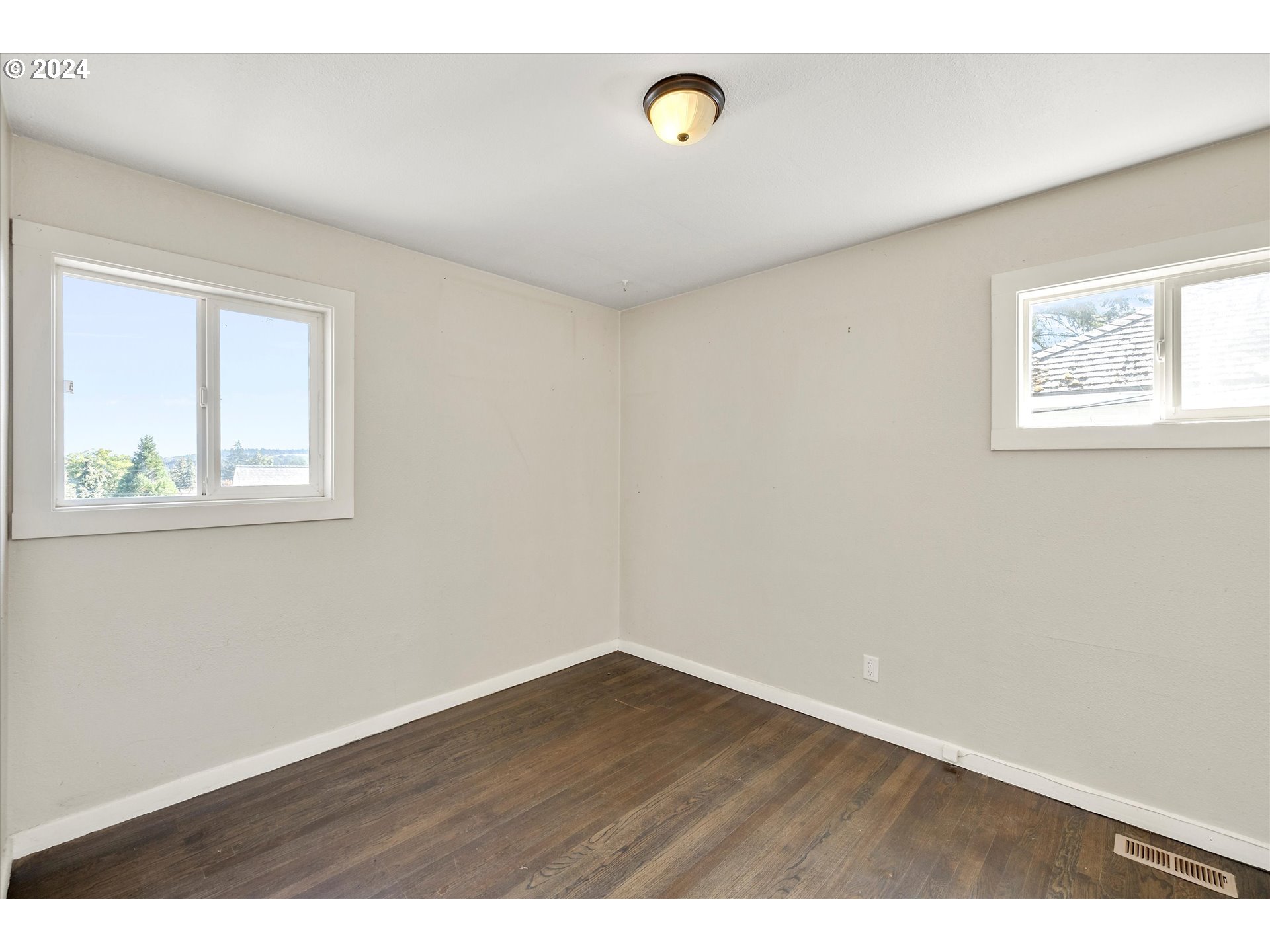 362 Southwest Oak Street Willamina, OR 97396 - Photo 15 of 34 a view of an empty room with wooden floor and a window