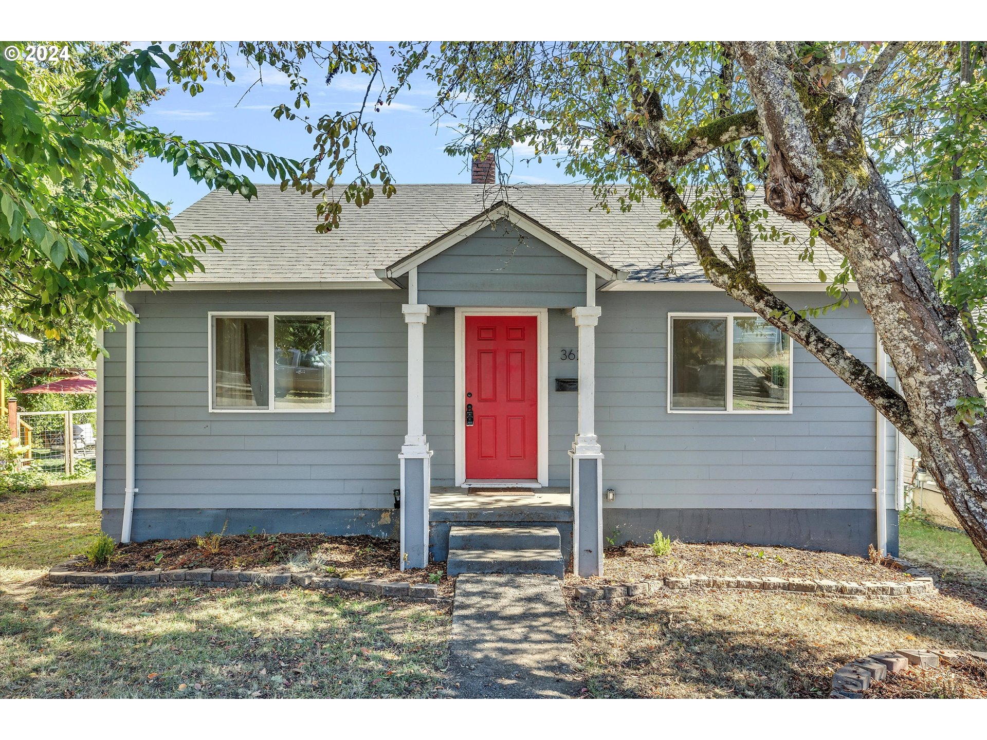 362 Southwest Oak Street Willamina, OR 97396 - Photo 3 of 34 a house that has a tree in front of it