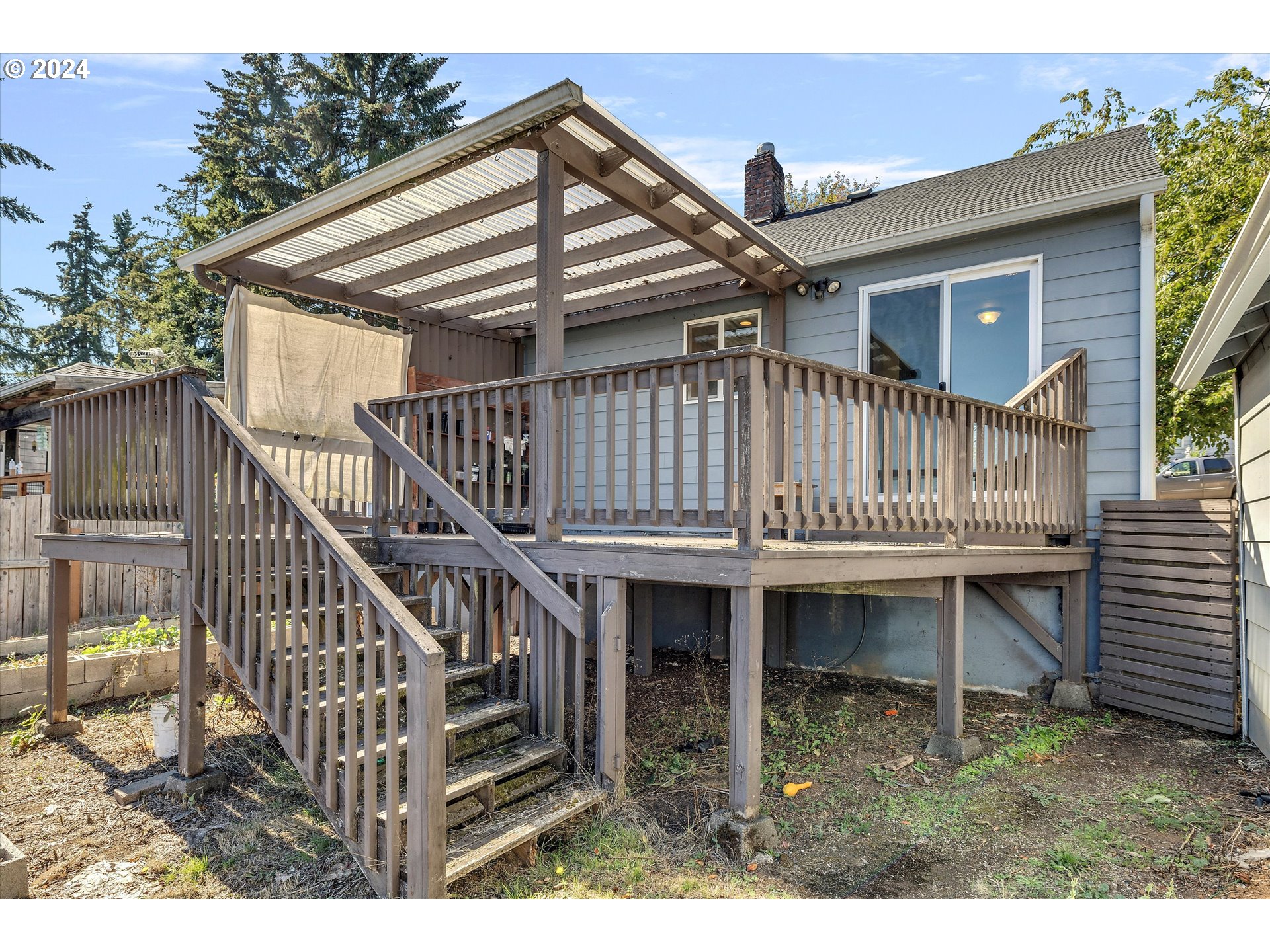 362 Southwest Oak Street Willamina, OR 97396 - Photo 32 of 34 a view of a house with wooden deck and furniture
