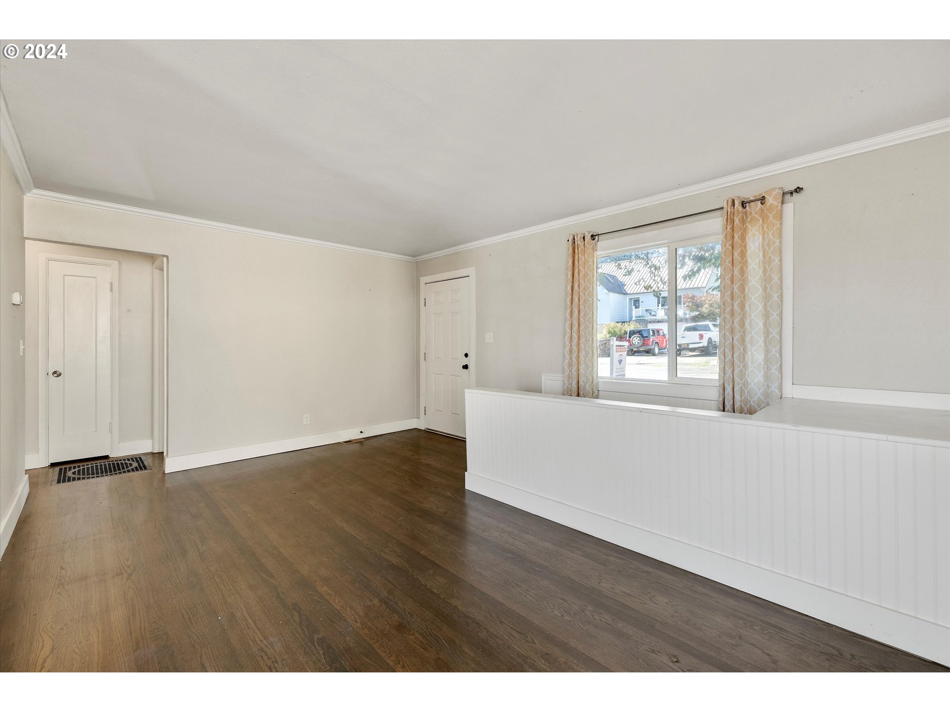 362 Southwest Oak Street Willamina, OR 97396 - Photo 8 of 34 a view of an empty room with wooden floor and a window