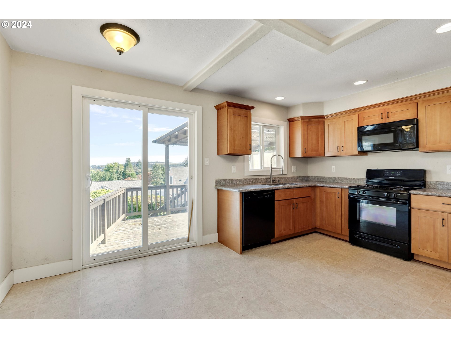 362 Southwest Oak Street Willamina, OR 97396 - Photo 9 of 34 a kitchen with stainless steel appliances granite countertop a stove a sink and a refrigerator