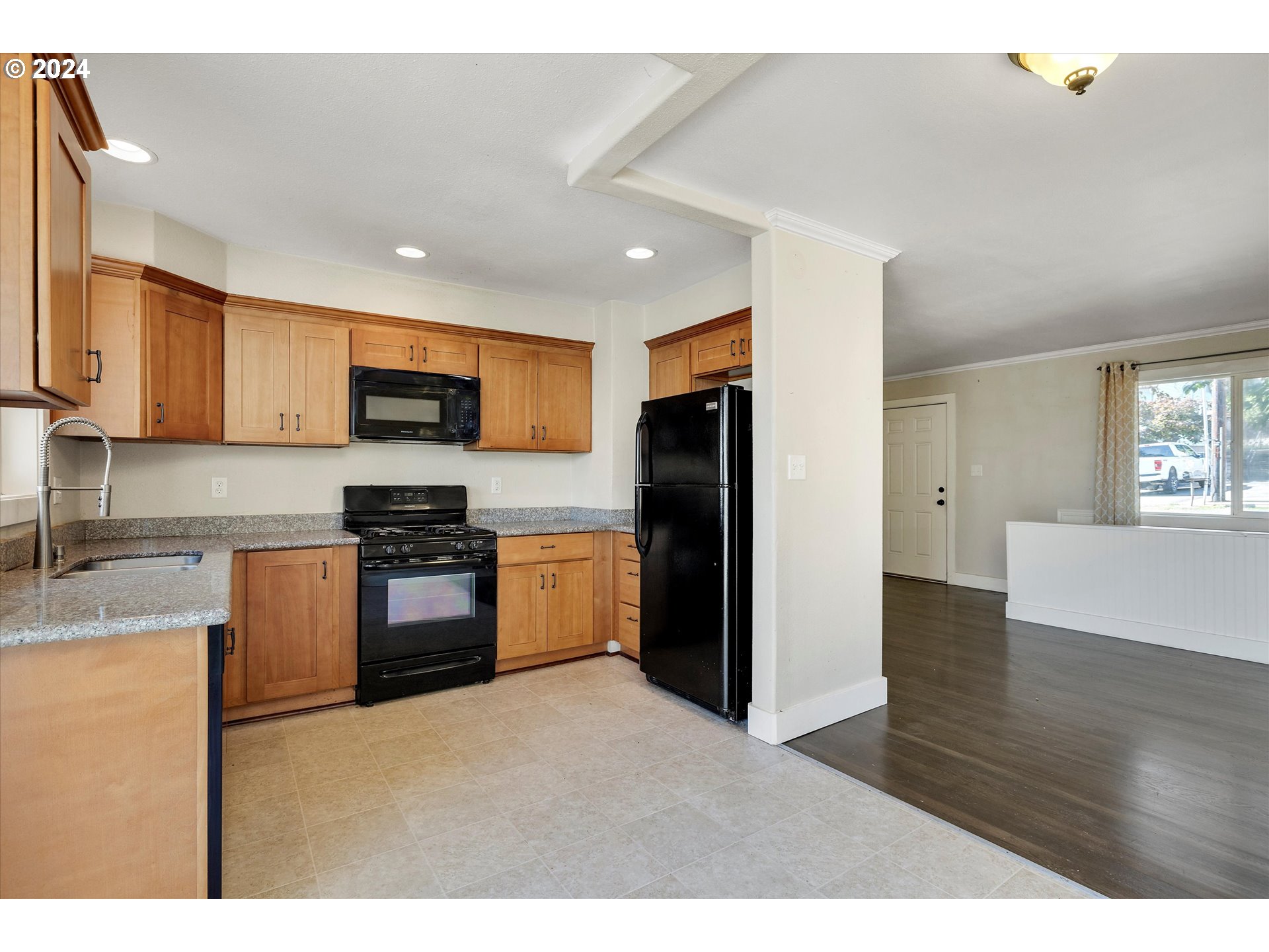362 Southwest Oak Street Willamina, OR 97396 - Photo 10 of 34 a kitchen with stainless steel appliances granite countertop a refrigerator stove top oven and sink