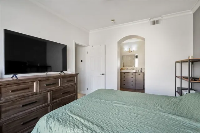 a bedroom with a bed and a flat screen tv