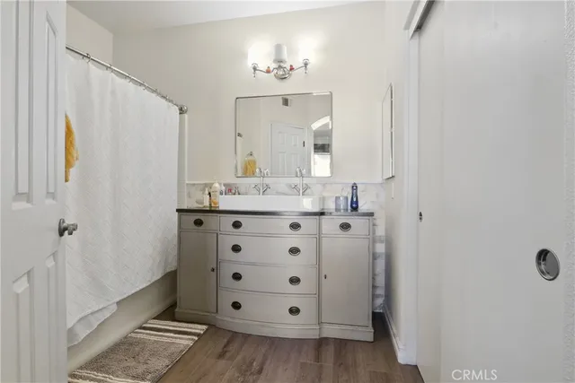 a bathroom with a double vanity sink and mirror