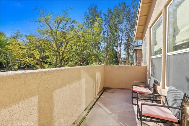 a view of balcony with wooden floor and fence