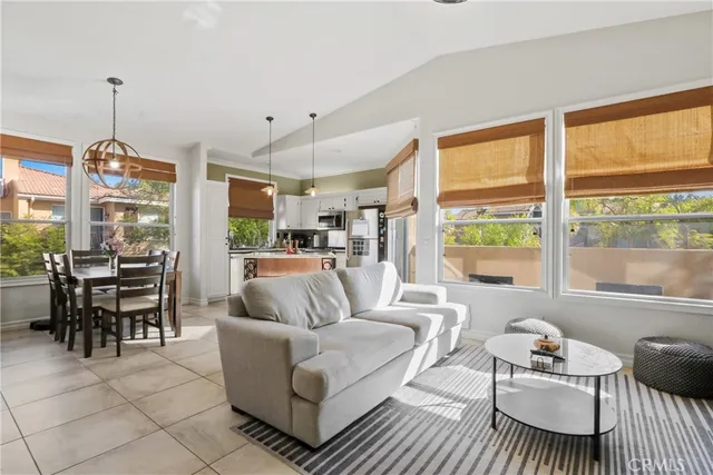 a living room with furniture a table and chairs