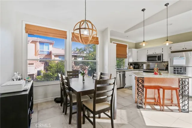 a dining room with furniture a chandelier and fireplace
