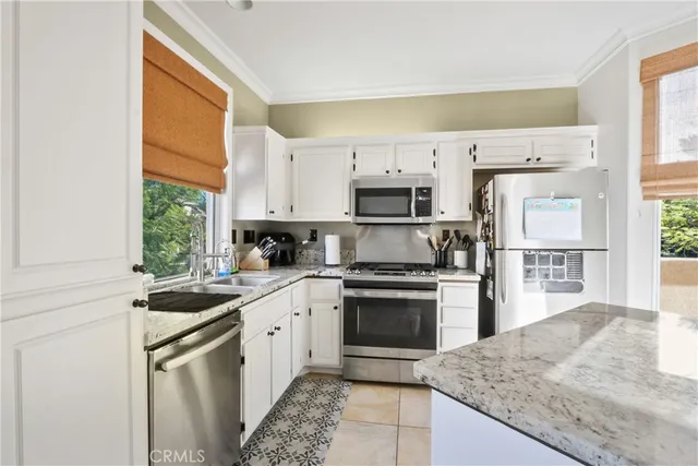 a kitchen with a sink stove and refrigerator