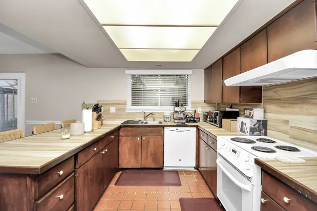 a kitchen with a sink stove and cabinets