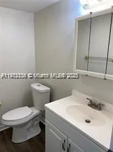 a bathroom with a sink a mirror and a toilet
