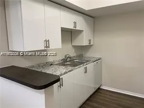 a kitchen with a sink and a stove