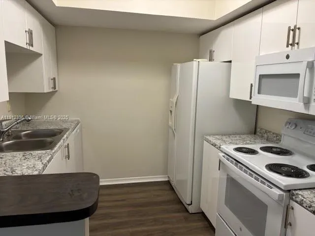 a kitchen with a stove a sink and a refrigerator