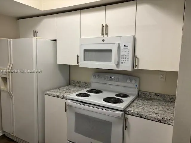 a kitchen with appliances cabinets and a counter top