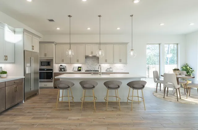 a large kitchen with a table and chairs