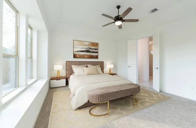 a bedroom with a bed and a painting on the wall