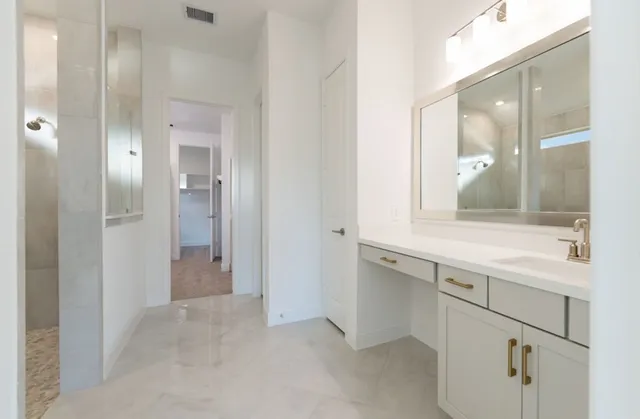 a bathroom with a granite countertop sink mirror and double