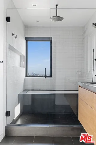 a bathroom with a bathtub and a shower