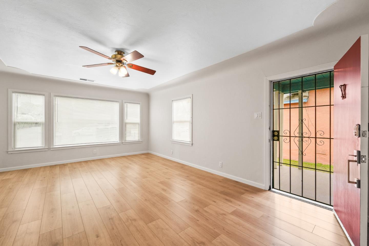 636 West 25th Street Merced, CA 95340 - Photo 12 of 31 wooden floor in an empty room with a window
