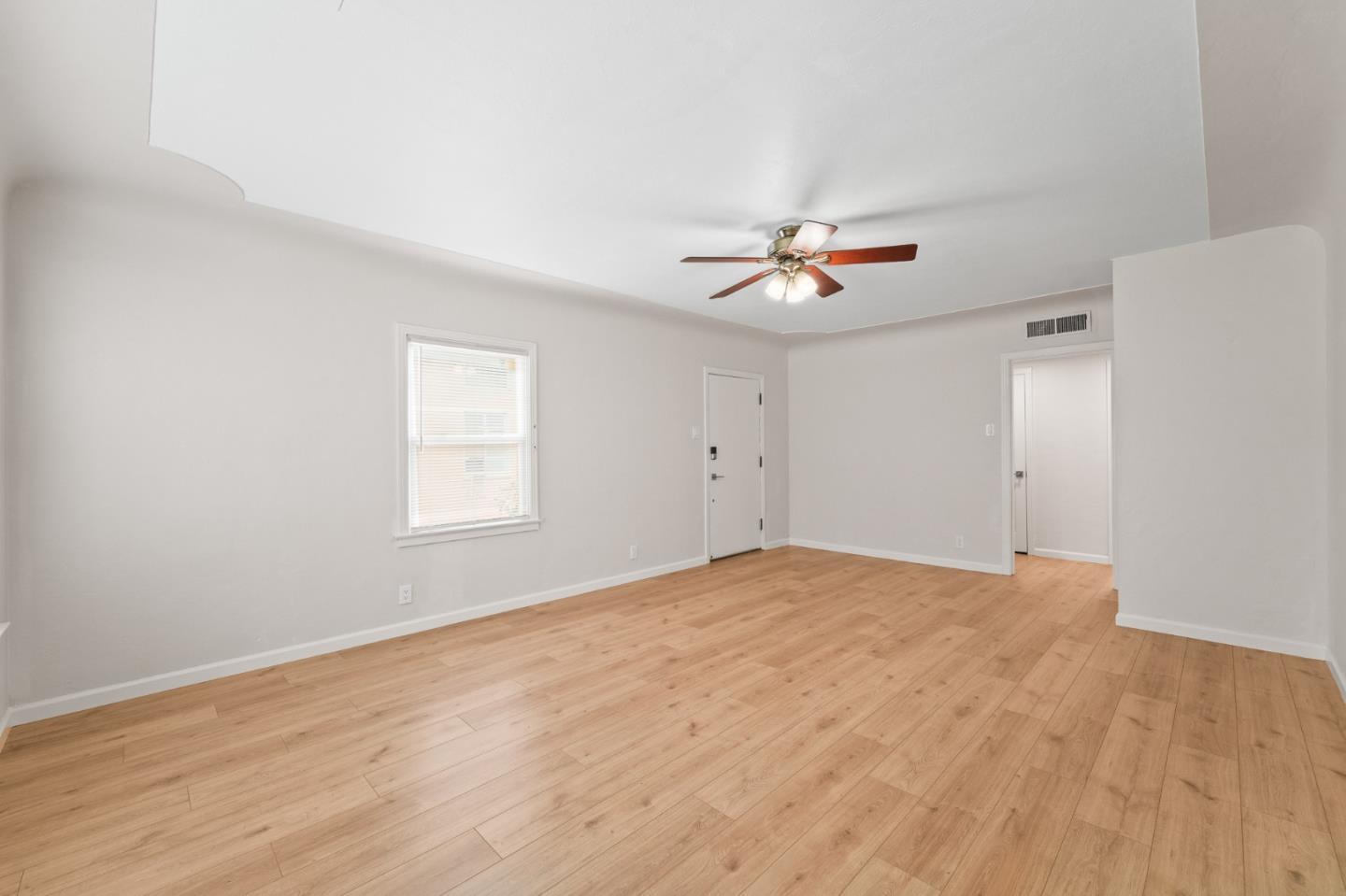 636 West 25th Street Merced, CA 95340 - Photo 13 of 31 a view of an empty room with chandelier fan and a window