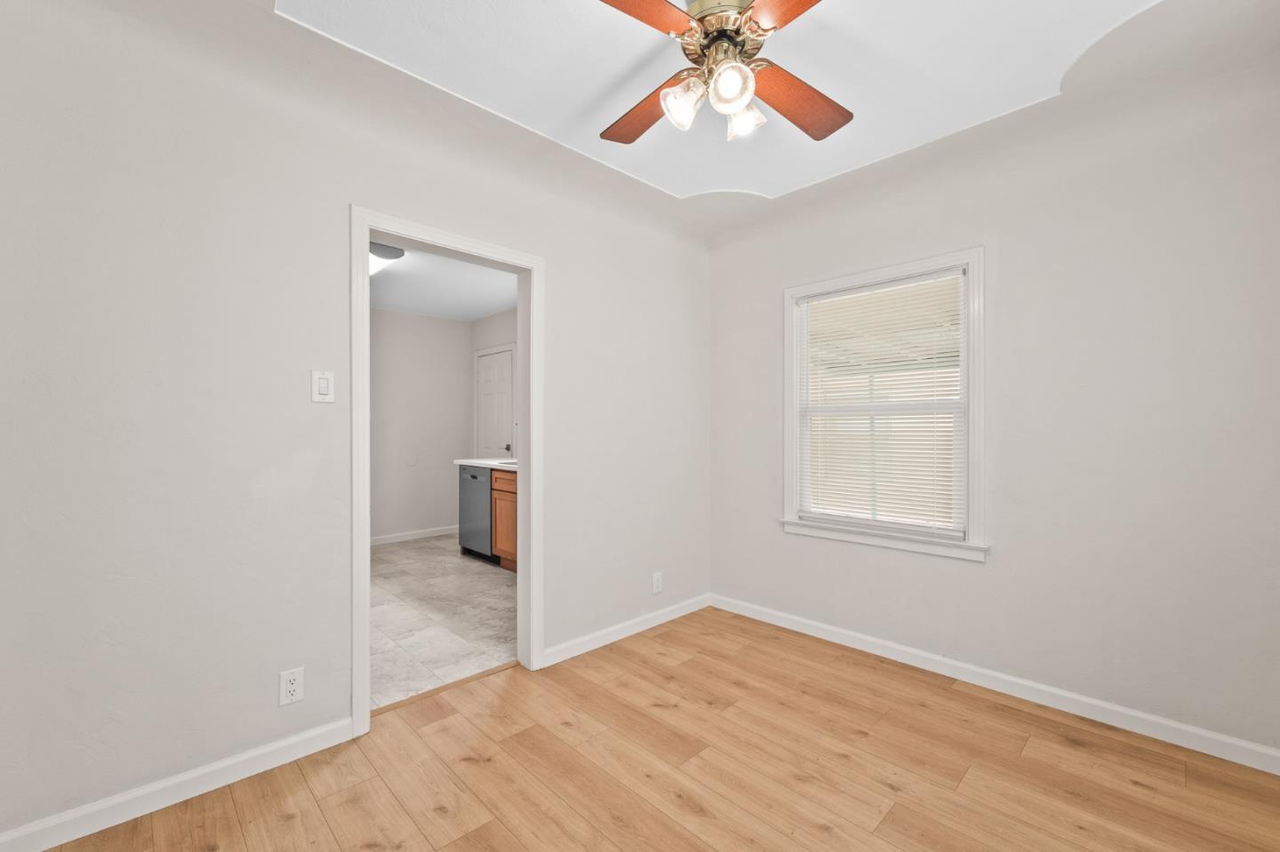 636 West 25th Street Merced, CA 95340 - Photo 16 of 31 an empty room with wooden floor chandelier fan and windows