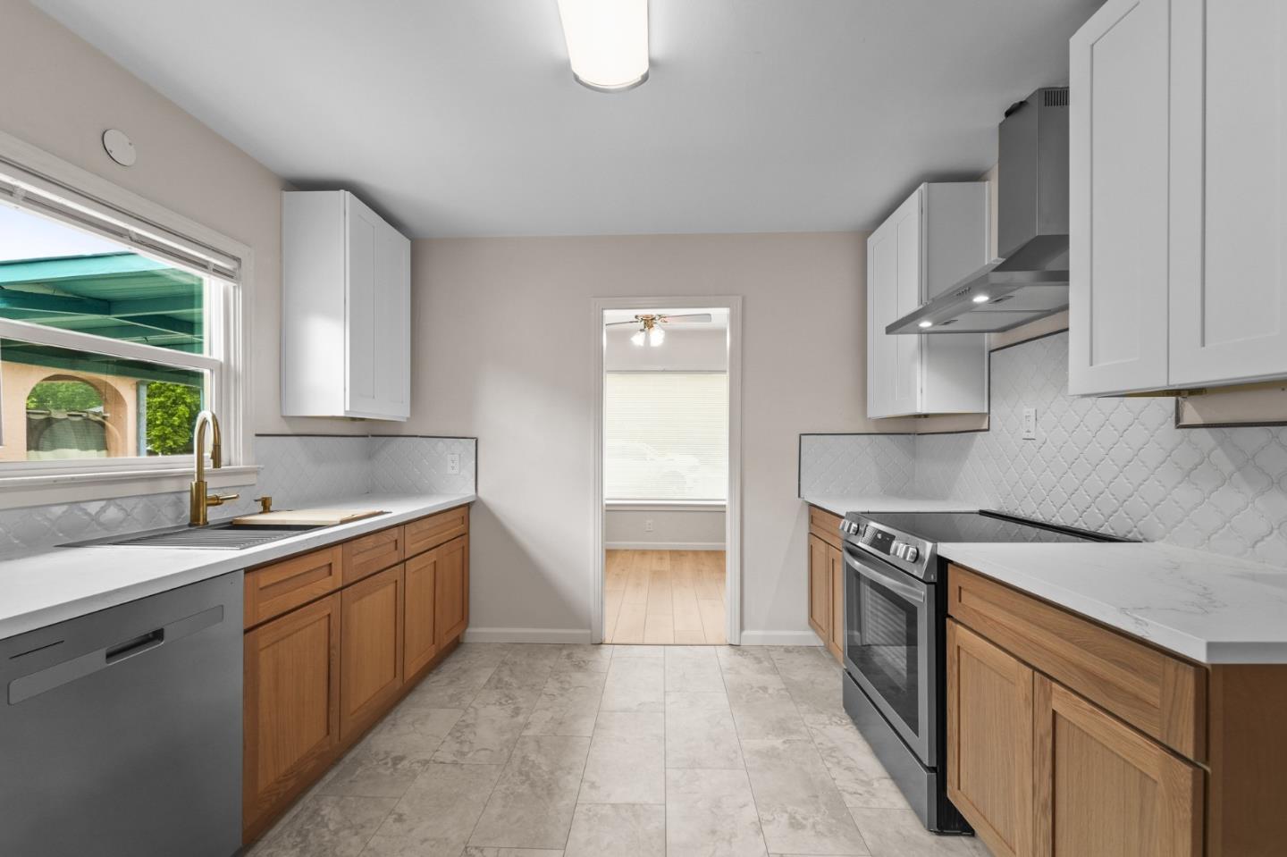 636 West 25th Street Merced, CA 95340 - Photo 18 of 31 a kitchen with a sink stove and cabinets