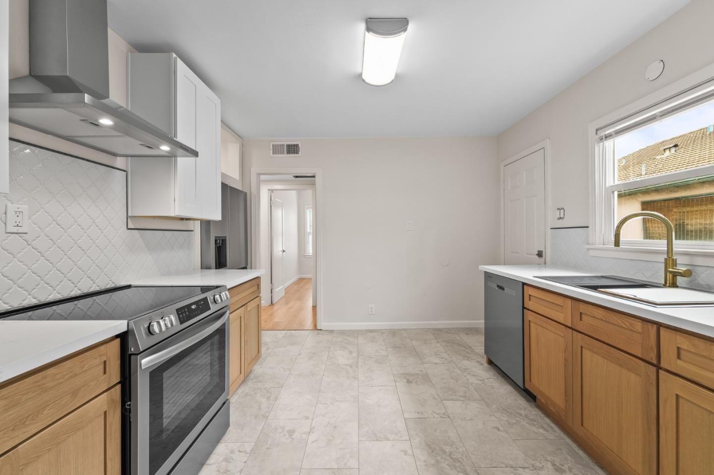 636 West 25th Street Merced, CA 95340 - Photo 19 of 31 a kitchen with stainless steel appliances granite countertop a sink stove and refrigerator
