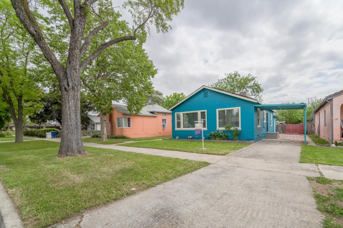 636 West 25th Street Merced, CA 95340 - Photo 8 of 31 a front view of a house with a yard and garage