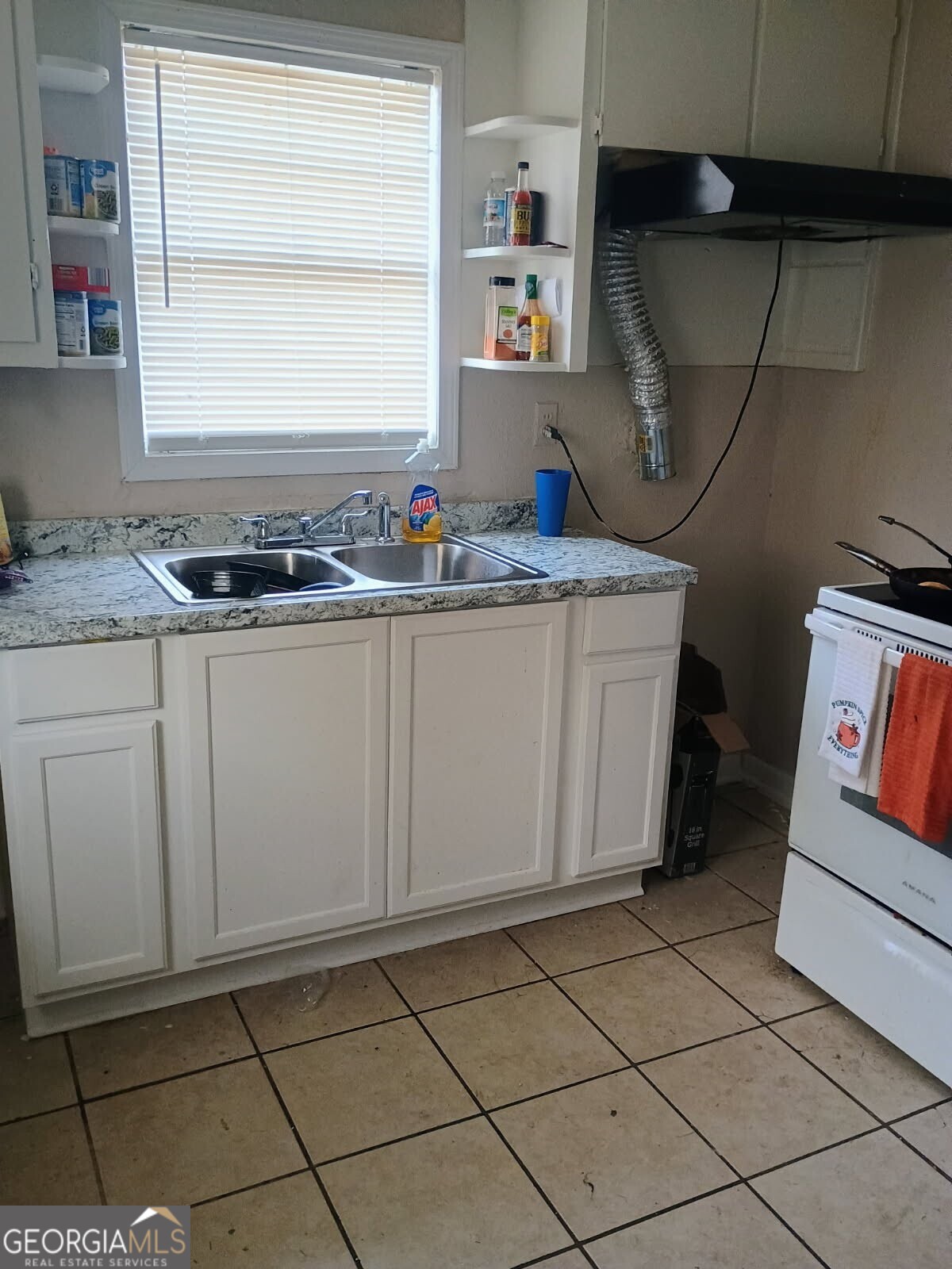 434 Mellon Street Columbus, GA 31903 - Photo 4 of 12 a kitchen with granite countertop cabinets a sink and a stove