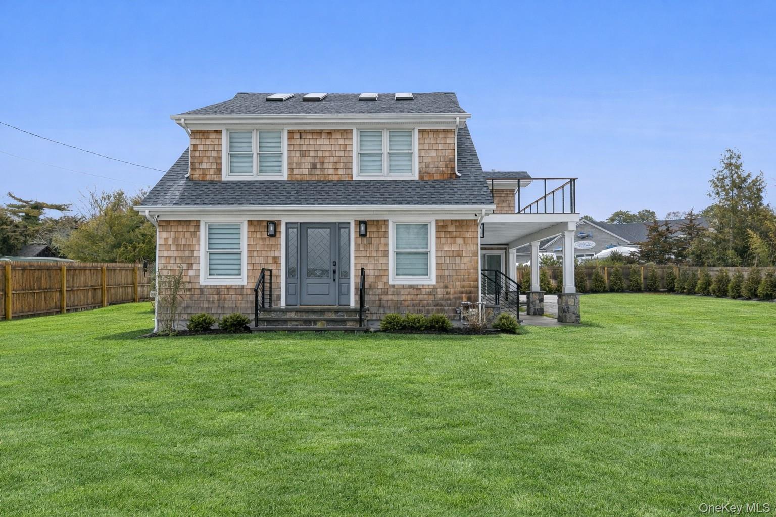10 Sagamore Road Hampton Bays, NY 11946 - Photo 4 of 41 a front view of a house with a garden
