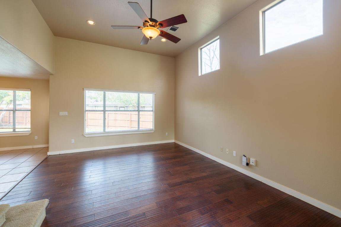 2102 Laura Court Round Rock, TX 78681 - Photo 2 of 32 an empty room with wooden floor and windows