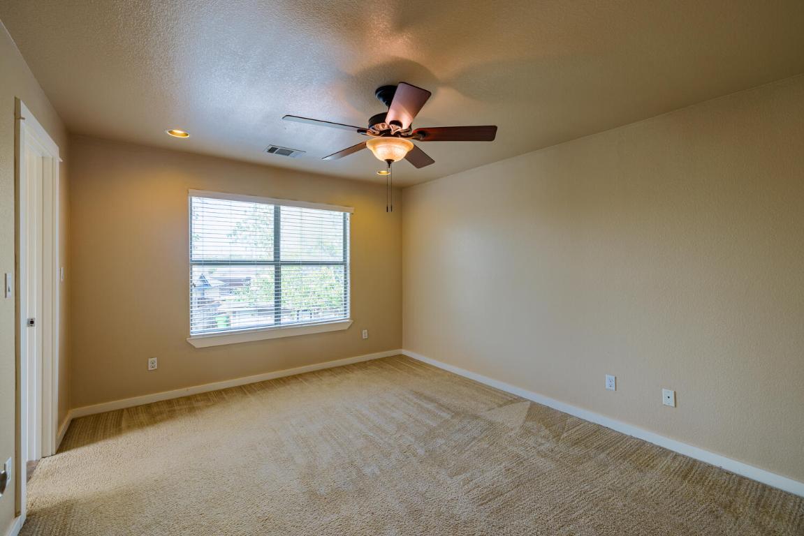 2102 Laura Court Round Rock, TX 78681 - Photo 23 of 32 an empty room with a window and a fan