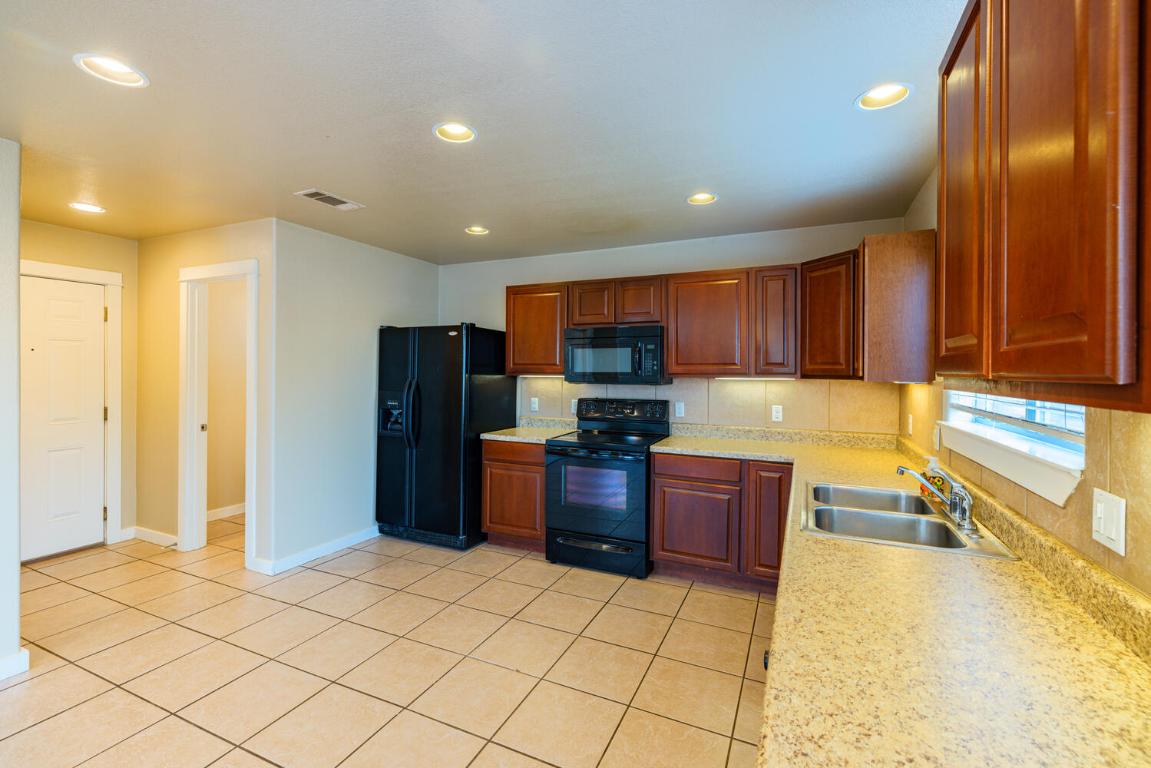 2102 Laura Court Round Rock, TX 78681 - Photo 9 of 32 a kitchen with a refrigerator and a sink