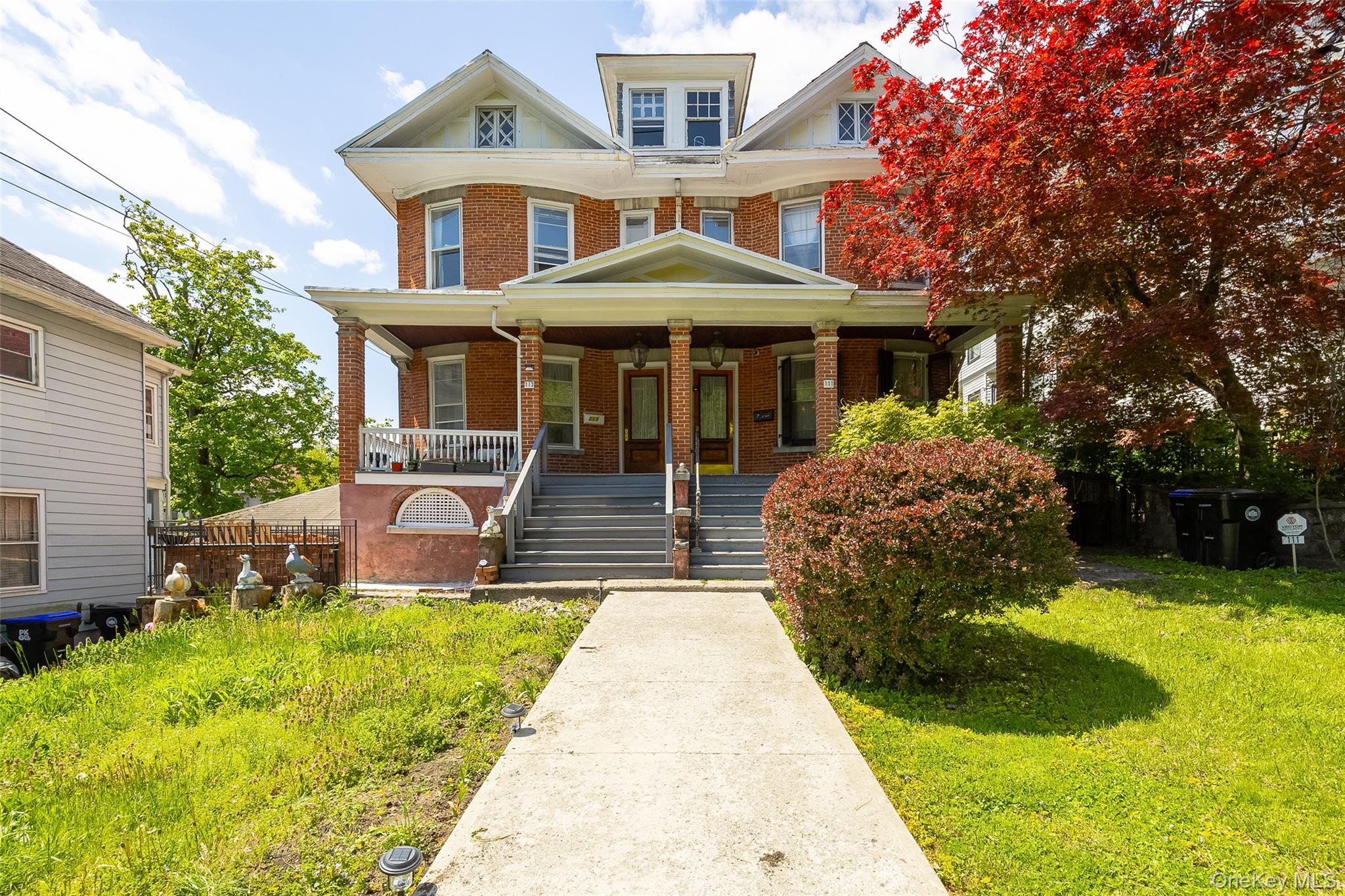 111 South Hamilton Street Poughkeepsie, NY 12601 - Photo 1 of 33 Brick multi-story residence featuring a covered front porch with multiple entry points, white railings, and column supports