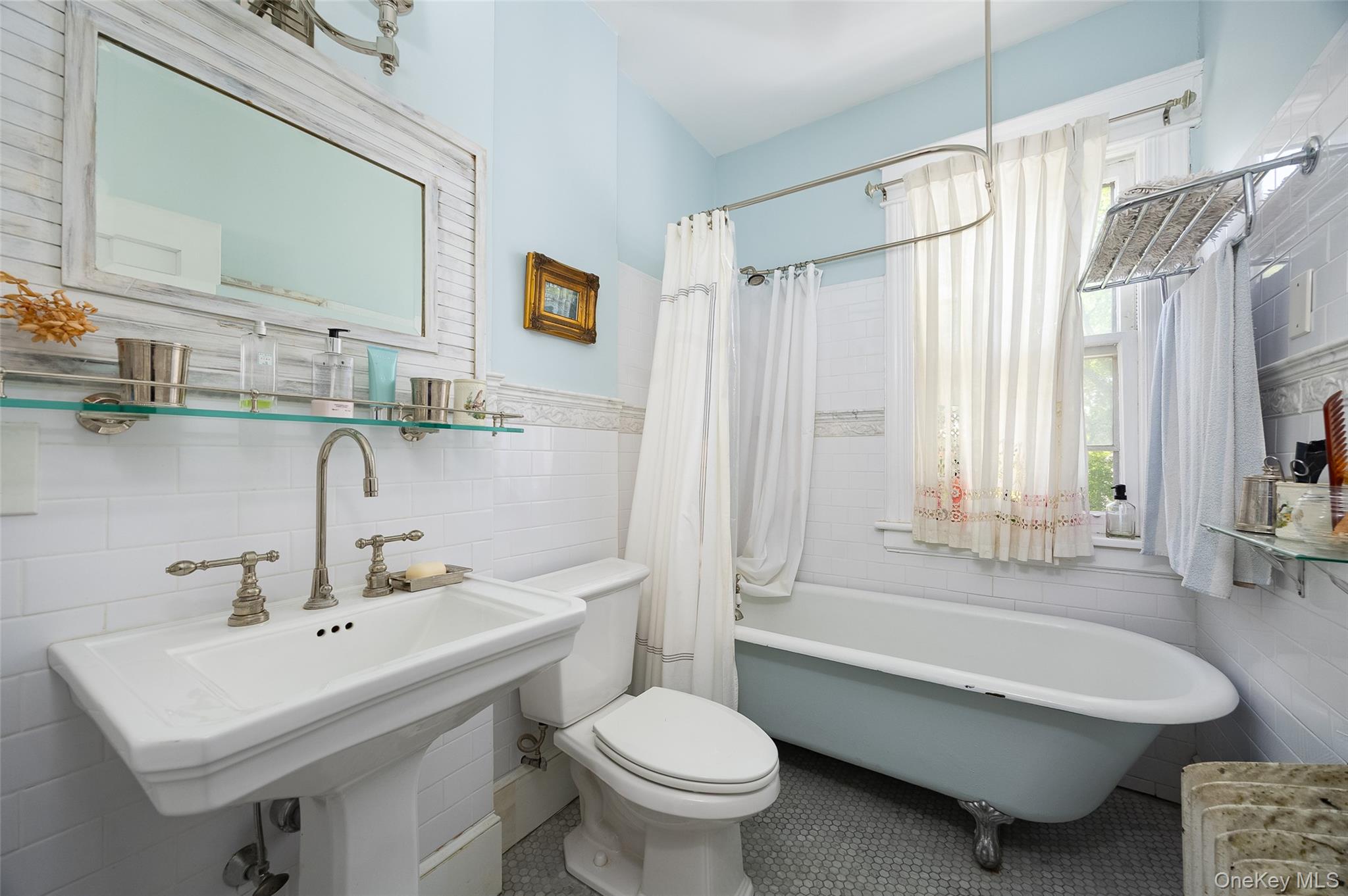 111 South Hamilton Street Poughkeepsie, NY 12601 - Photo 16 of 33 Bathroom featuring a clawfoot tub, pedestal sink with brushed nickel fixtures, subway tile wainscoting, and mosaic tile flooring