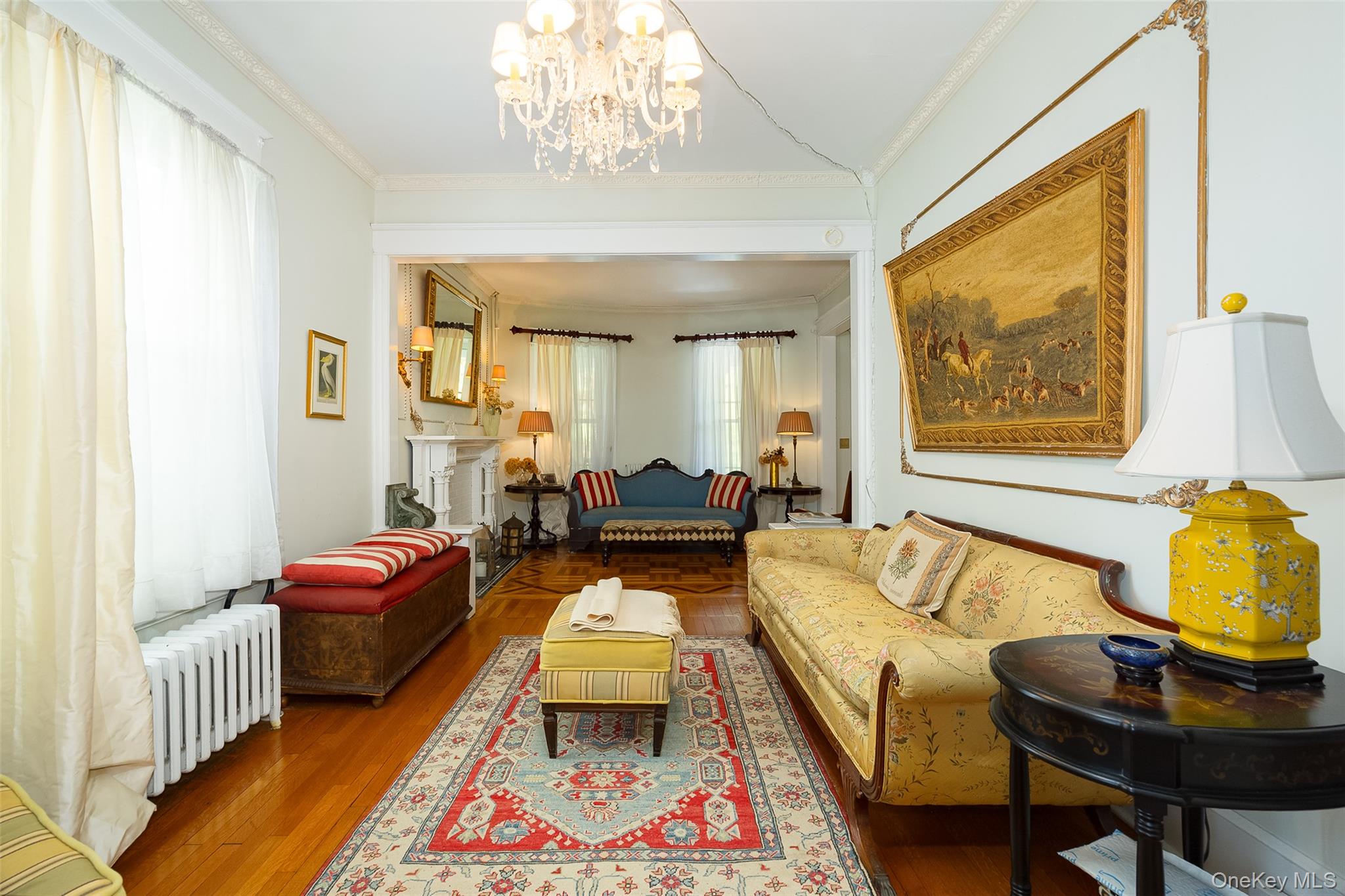 111 South Hamilton Street Poughkeepsie, NY 12601 - Photo 7 of 33 Living area featuring wood-finish flooring, an ornate crown molding, a decorative ceiling medallion, and a chandelier