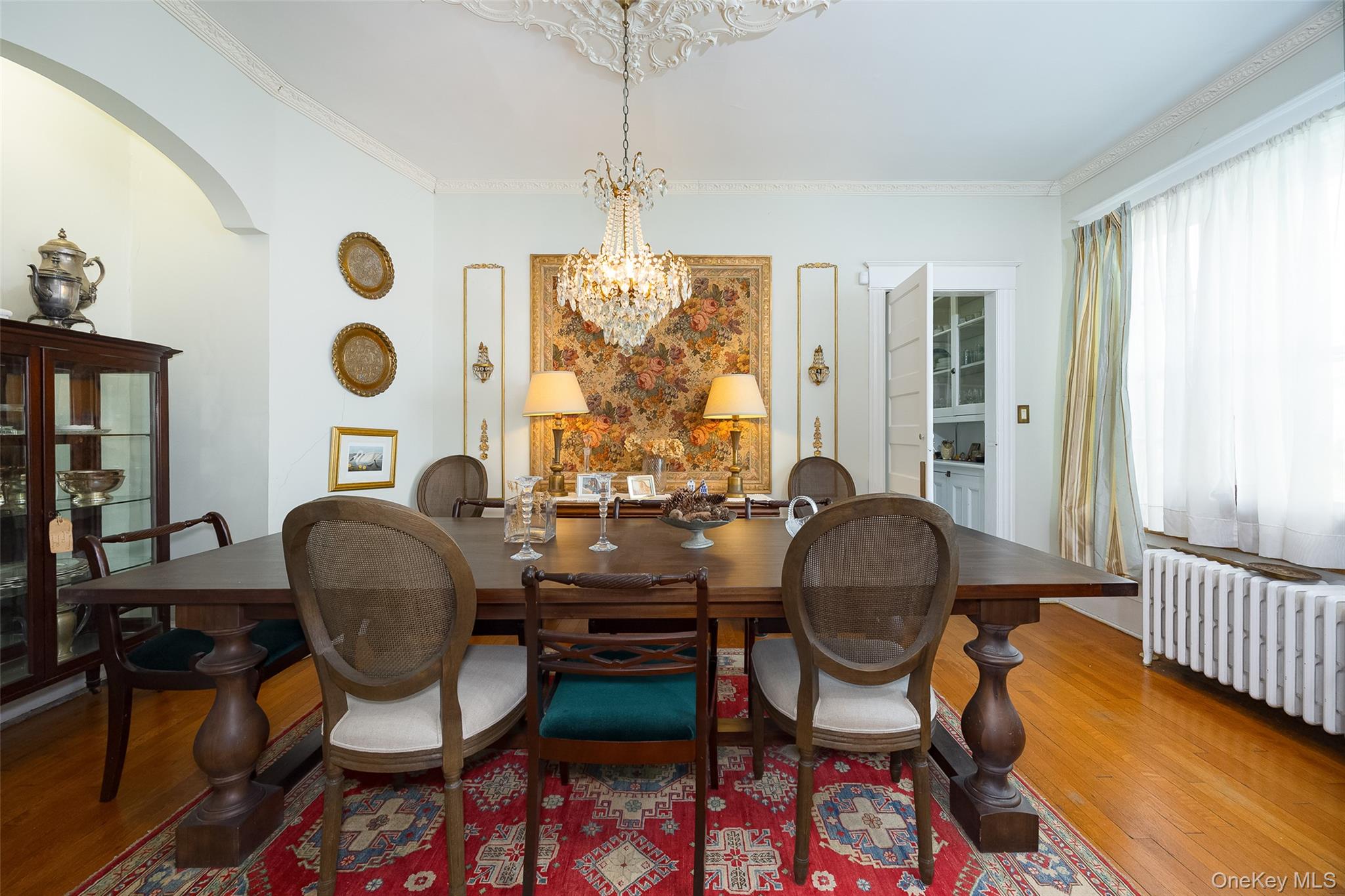 111 South Hamilton Street Poughkeepsie, NY 12601 - Photo 8 of 33 Formal dining space featuring hardwood flooring, a decorative chandelier, and an arched entryway