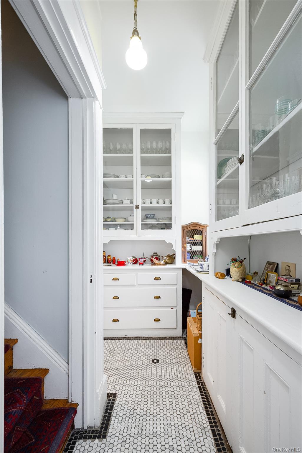 111 South Hamilton Street Poughkeepsie, NY 12601 - Photo 10 of 33 Kitchen corridor featuring white cabinetry, glass-front upper cabinets, and a built-in lower cabinet with drawers
