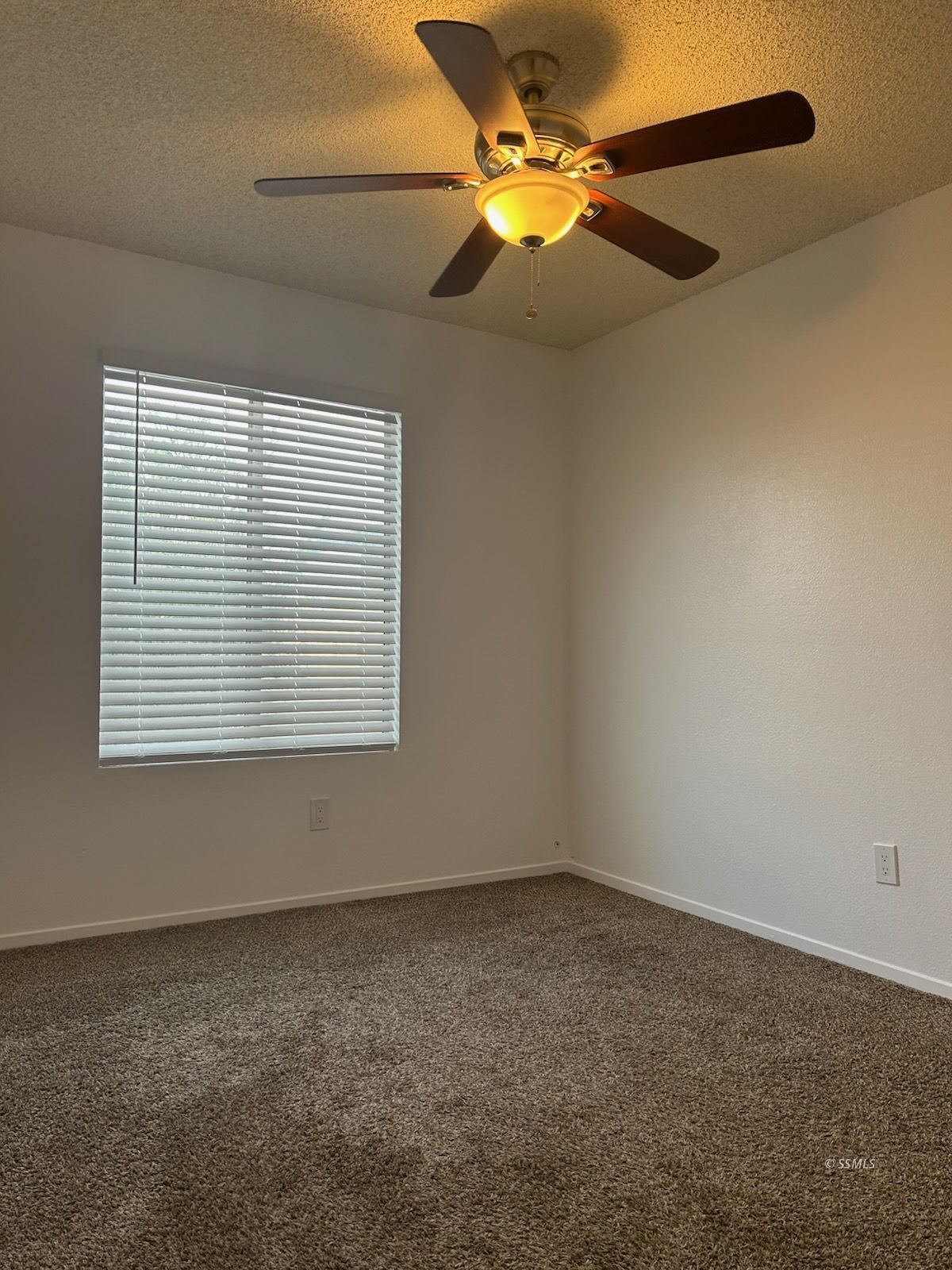 824 C Capehart Court Ridgecrest, CA 93555 - Photo 6 of 11 an empty room with a window and a fan