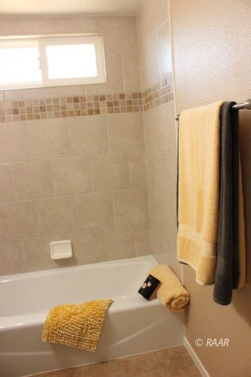325 North Norma Street Ridgecrest, CA 93555 - Photo 13 of 25 a bathroom with a bathtub and shower