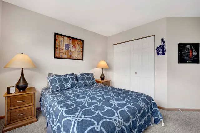 a bedroom with a bed and a lamp on table