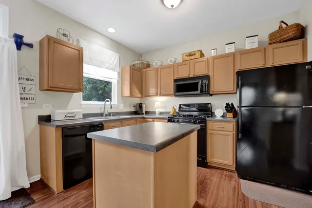 a kitchen with granite countertop a sink stove and refrigerator