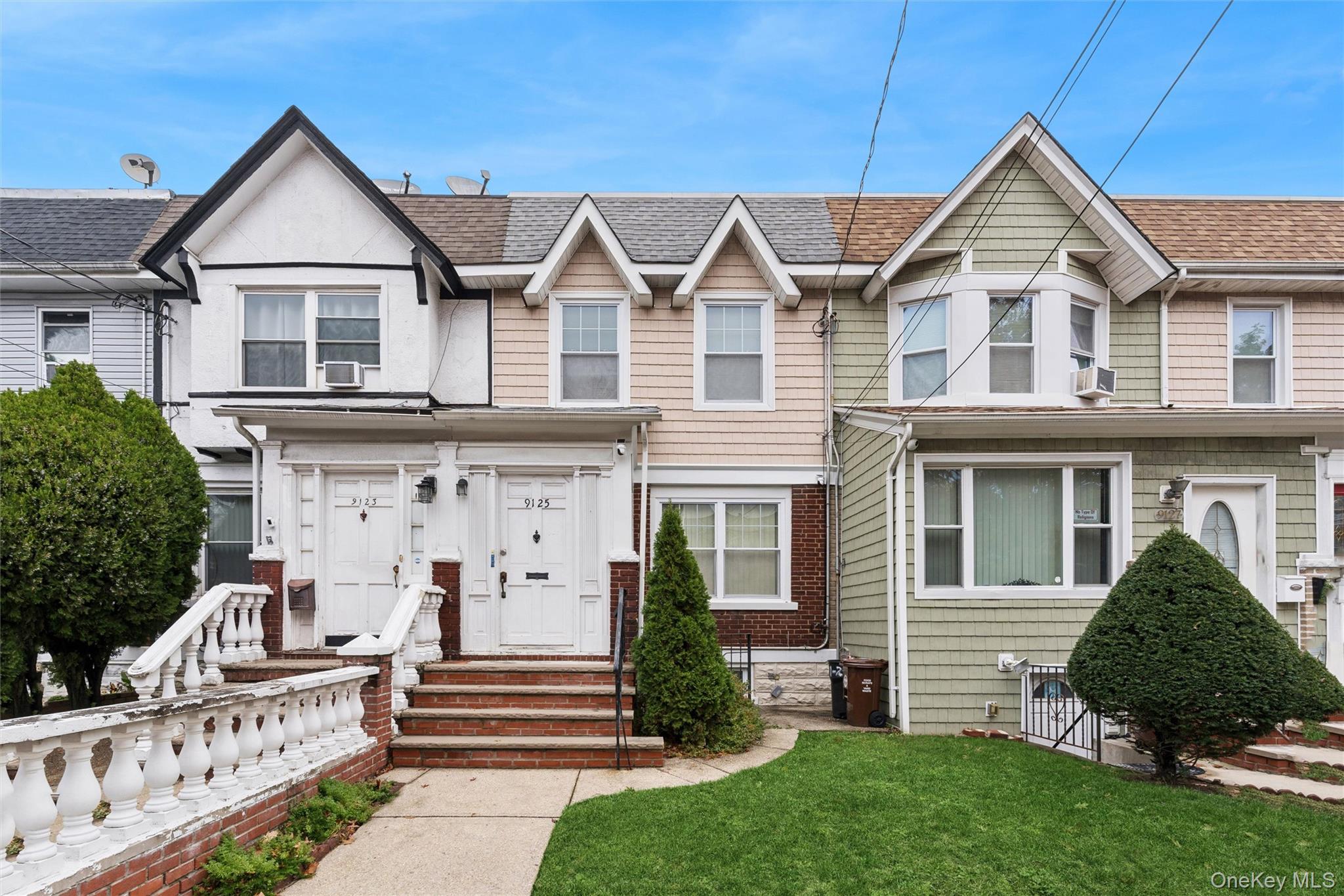 91-25 90th Street Queens, NY 11421 - Photo 1 of 30 View of front facade featuring a shingled roof and a front lawn