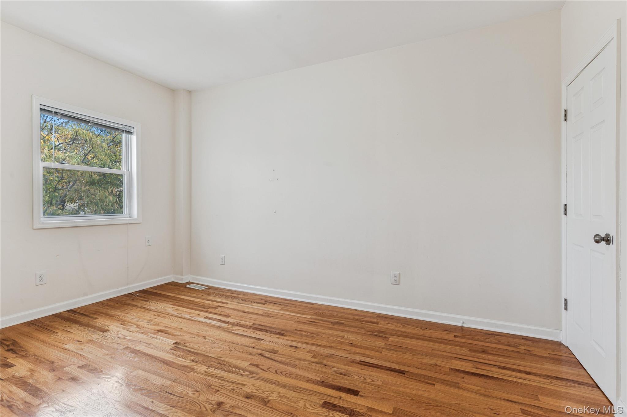 91-25 90th Street Queens, NY 11421 - Photo 14 of 30 Unfurnished room featuring light wood-style floors and baseboards