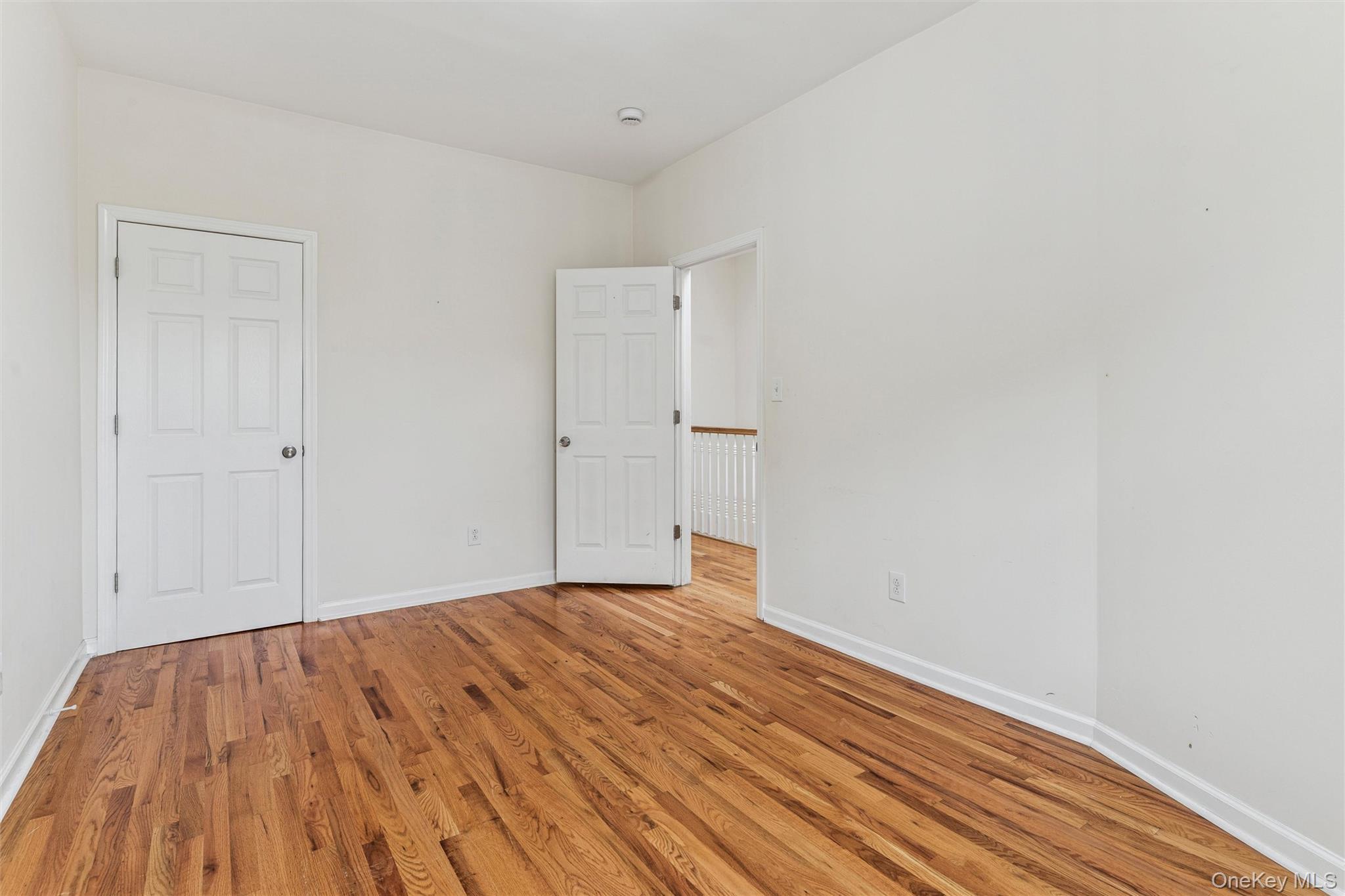 91-25 90th Street Queens, NY 11421 - Photo 15 of 30 Unfurnished bedroom with baseboards and wood finished floors