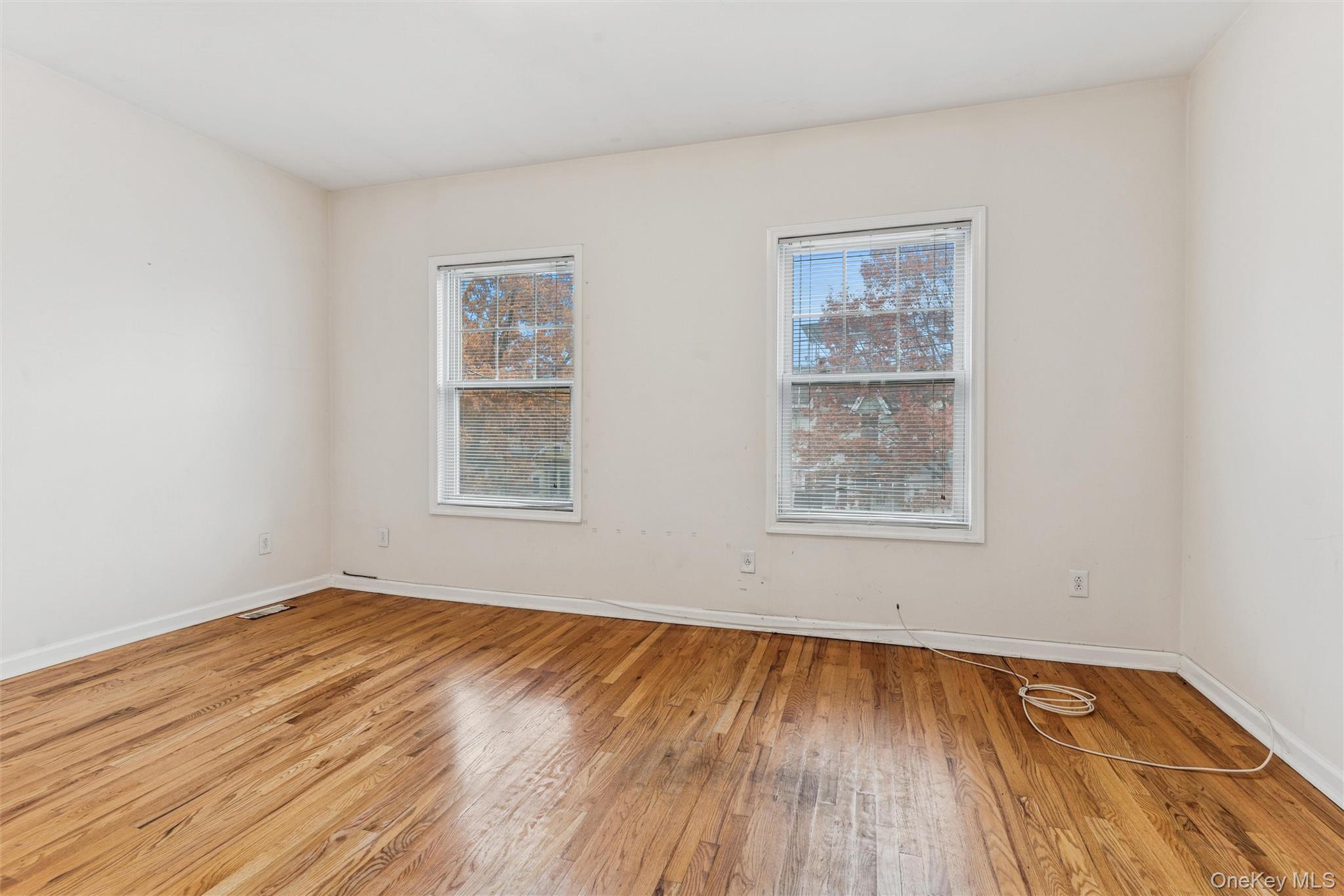 91-25 90th Street Queens, NY 11421 - Photo 17 of 30 Empty room featuring light wood-style flooring and baseboards
