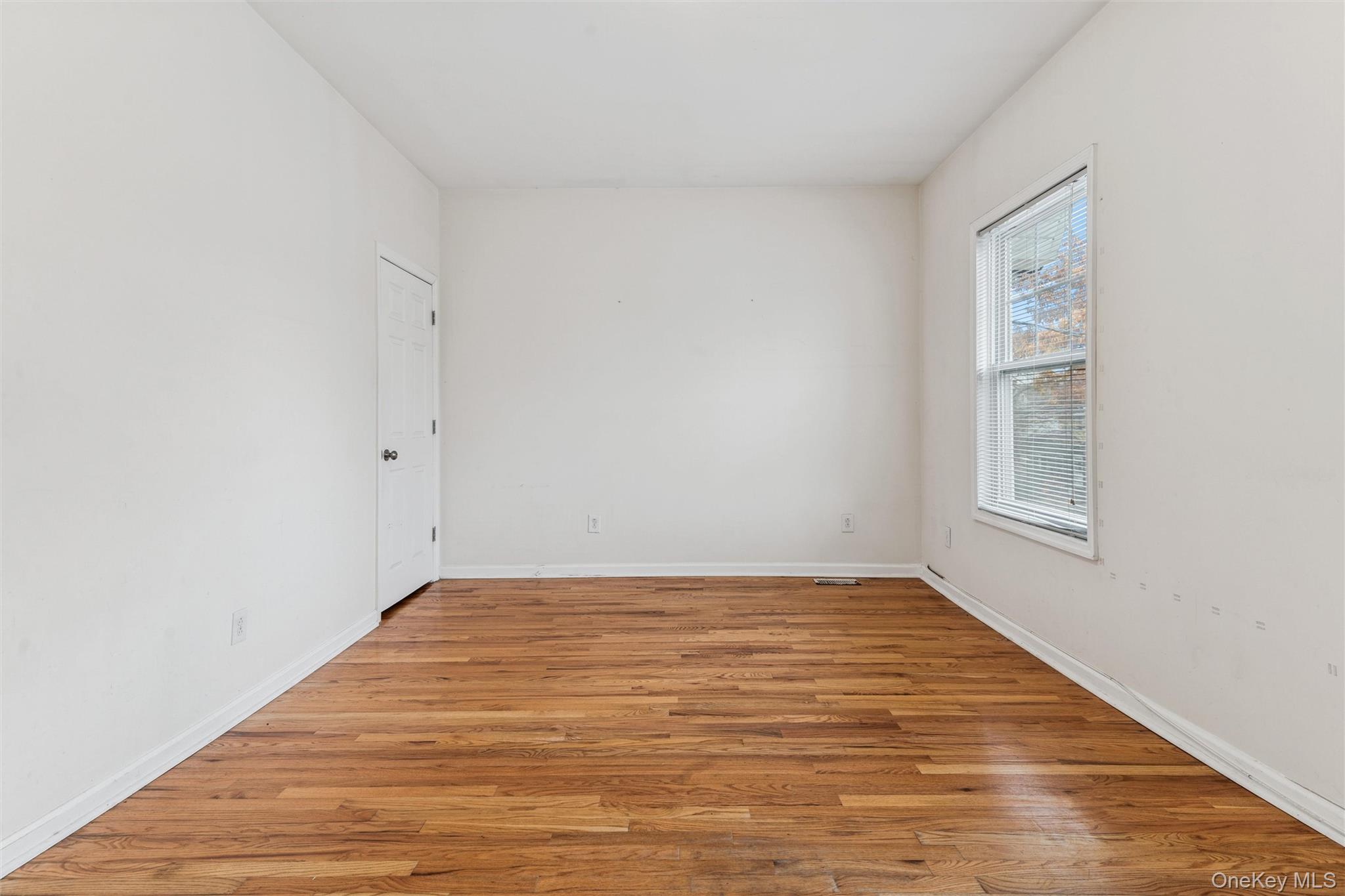 91-25 90th Street Queens, NY 11421 - Photo 19 of 30 Empty room with light wood-type flooring