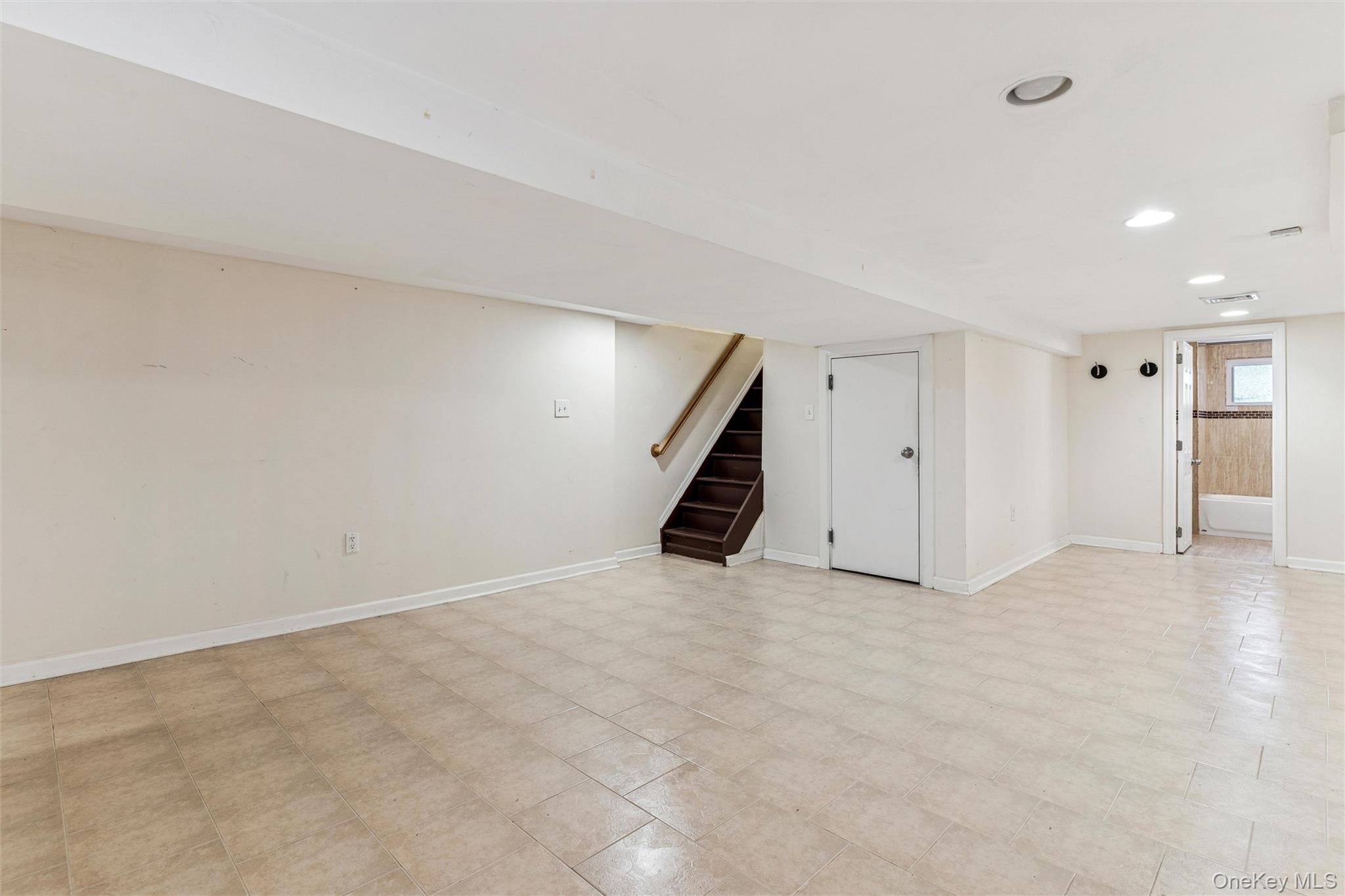 91-25 90th Street Queens, NY 11421 - Photo 23 of 30 Basement with stairway and recessed lighting